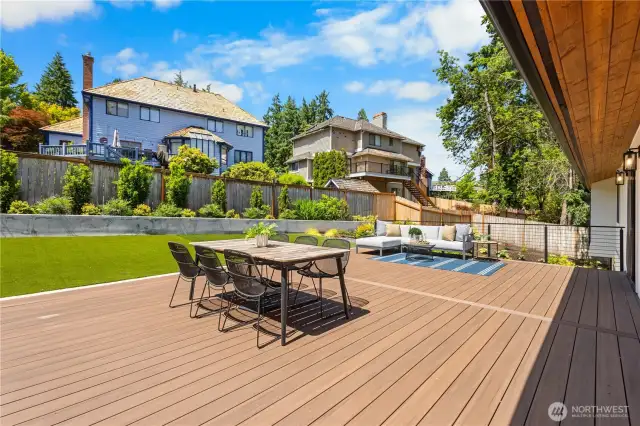 The backyard is an entertainer's dream featuring a new Trex patio and modern railing installed in 2022.