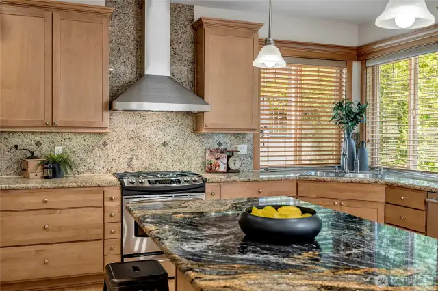 With rich slab granite countertops, a generous center island, and both a butler’s pantry and a separate food storage pantry, this space is as functional as it is stylish.