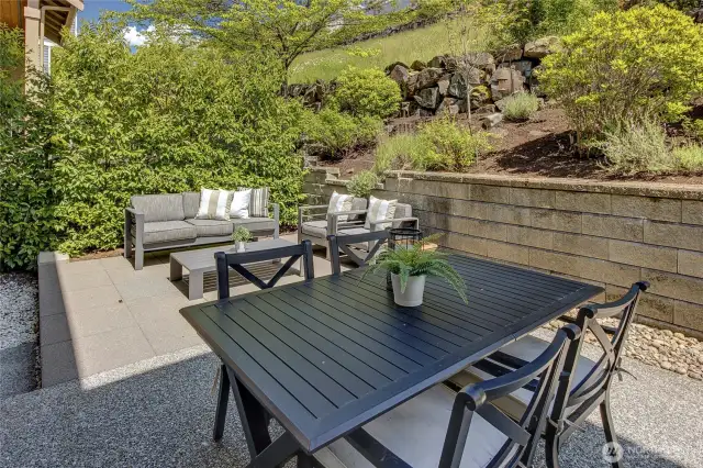 Thoughtfully designed with low-maintenance pavers, it’s the perfect spot to relax, entertain, or showcase your favorite potted plants in a sun-dappled garden setting.