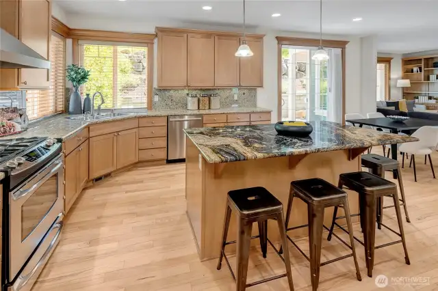 The heart of the home is the expansive kitchen, featuring hardwood floors that flow seamlessly into the adjoining great room.
