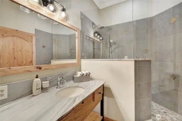 Hall bathroom with walk in shower is conveniently located close to bedrooms 2 and 3.