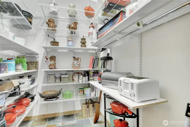 Walk in pantry with custom shelving.