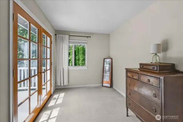 Primary Bedroom with French doors to Private Deck. Has 5 Piece Primary Bathroom Suite complete with Glass Surround Shower, Jetted Soaking Tub, and His & Her Sinks with walk In Closet