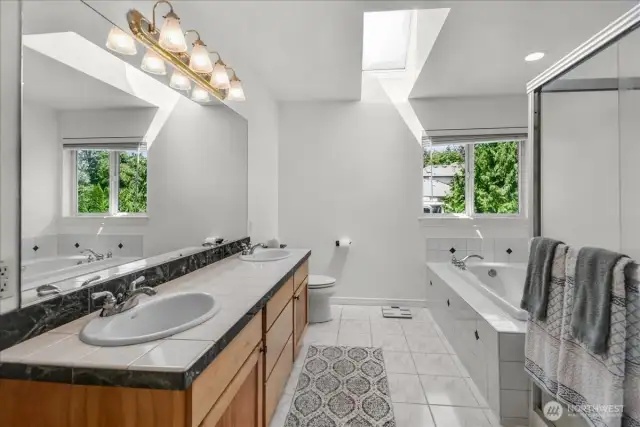 5 pc Primary Bathroom Suite with Jetted Soaking Tub, Glass Surround Shower, and His & Her Sinks along with a Walk In Closet