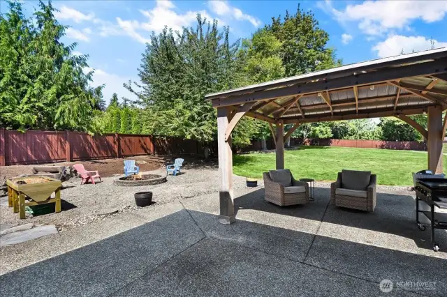 Large Fully Fenced In Back Yard with Storage Shed, Fire Pit, Patio, and Gazebo