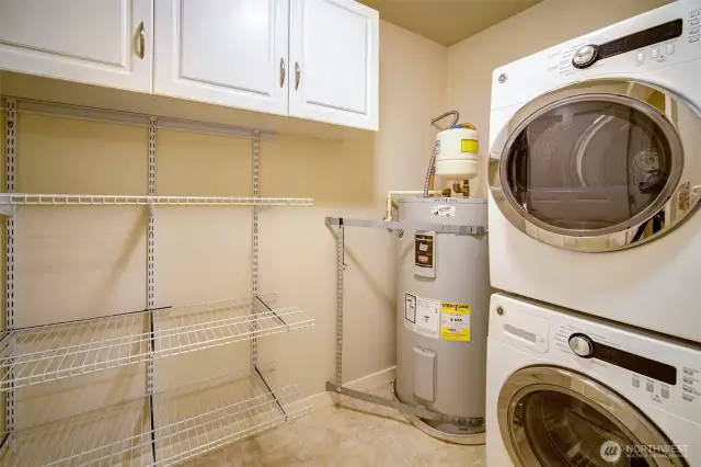Utility room in the unit with washer, dryer and great storage space.