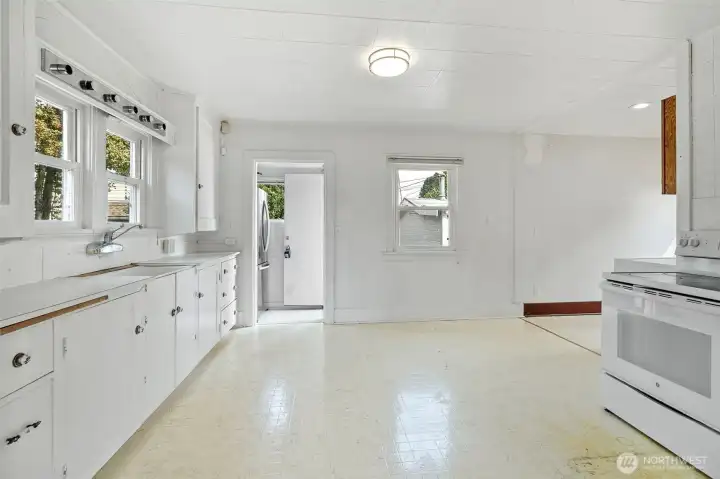 Kitchen door leads to fenced back yard