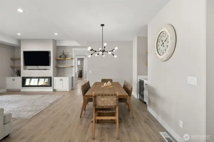 Dining area includes a wet bar with a convenient beverage fridge.