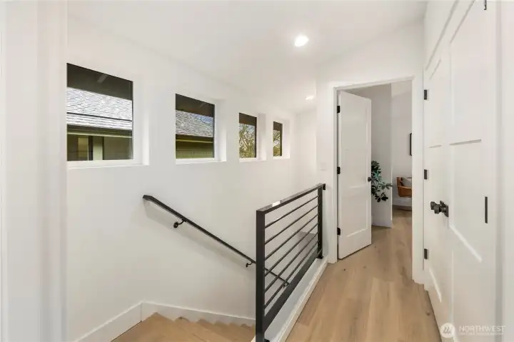 Stair case has plenty of natural light, hardwood floors throughout upper level