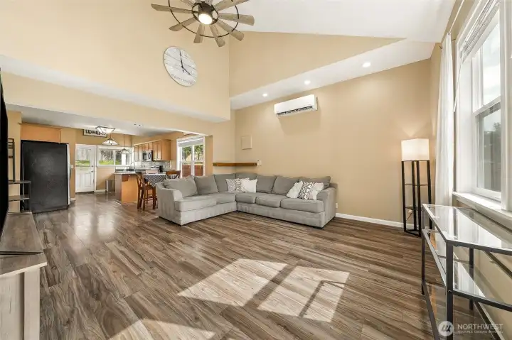High ceilings grace the entrance with a ceiling fan, dual split A/C, and lots of natural light.