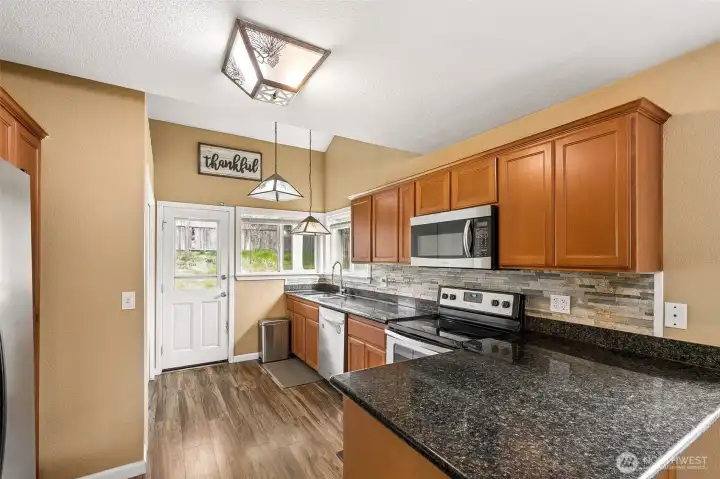 Functional kitchen with peninsula bar. Updated counters and backsplash.