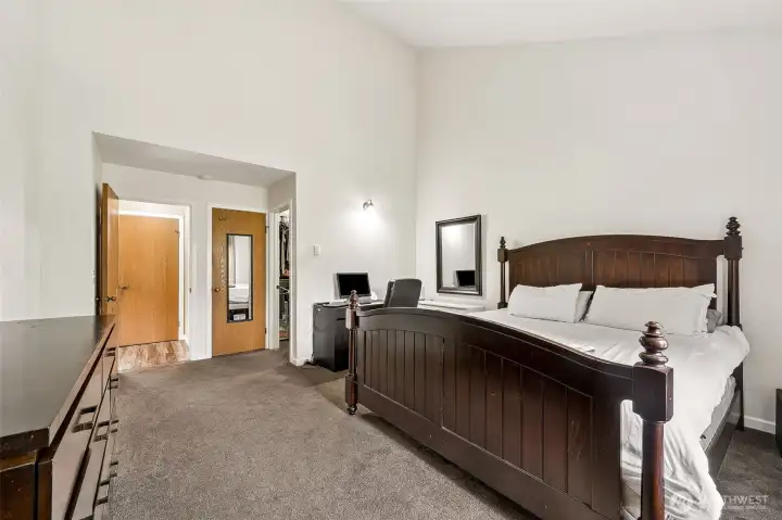 Primary bedroom with high ceilings and lots of space.