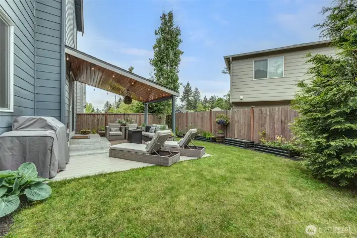 Lush backyard with established garden and vegetable beds. Lush backyard with established garden and vegetable beds.