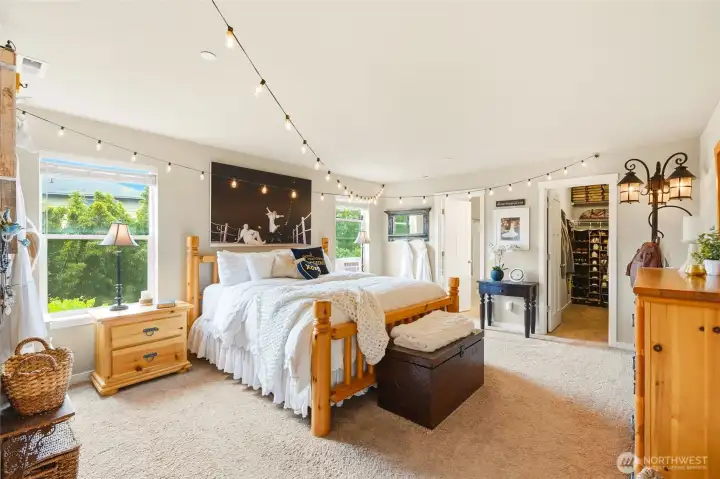 Large primary suite with spacious walk-in closet. The string lights are easily removable, they are decorative, yet operational Large primary suite with spacious walk-in closet. The string lights are easily removable, they are decorative, yet operational