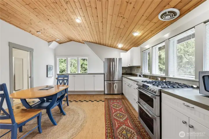 Hand stenciled finished plywood floor and a full-sized kitchen.