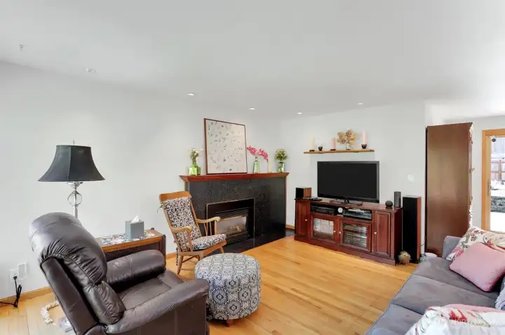 Oak Hardwood floors and gas fireplace with granite surround make the living room an inviting place.