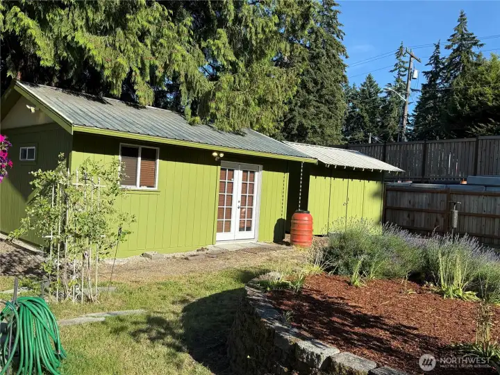Building with windows and french doors is a fully insulated workshop split into 2 rooms wtih peg board on all walls and long bars of outlets approx 2 ft above floor. Other building is garden shed also fully insulated with peg board and the 1954 kitchen cabinet sets.