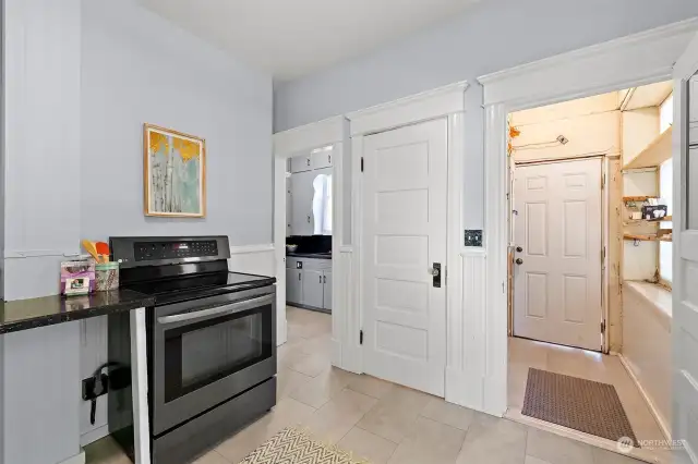 Kitchen provides access to the back parking through the mud-room providing ease of bring in groceries and supplies. Door in the center provides you with a water closet and entry on the left is an additional kitchen space to appreciate.