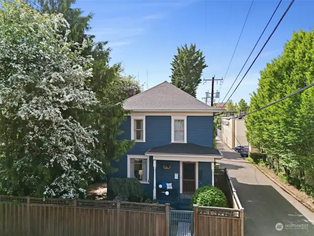Drone view showcasing the alley leading to the private parking and fully fenced private yard.