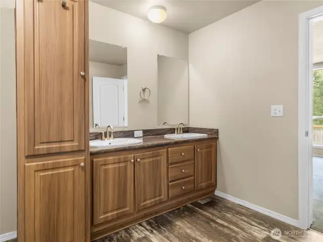This spacious bathroom has double sinks, beautiful cabinetry and room for everyones comfort