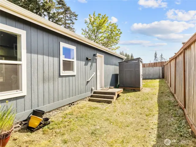Back door gives entry to the utility/mudroom.  Perfect spot for a dog run too.