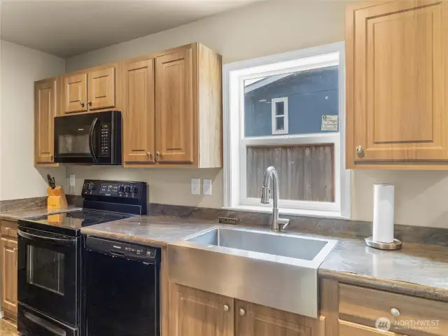 Like new appliances, large stainless steel farm sink and views out to your garden yard