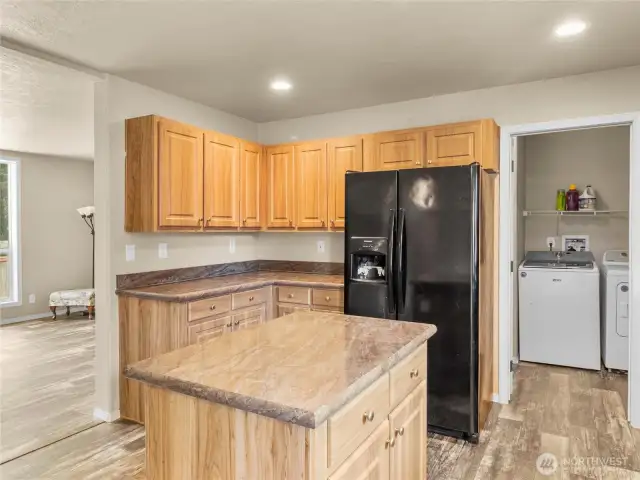 View to the utility/mud room has area for pantry storage and door leading outside to the garden.