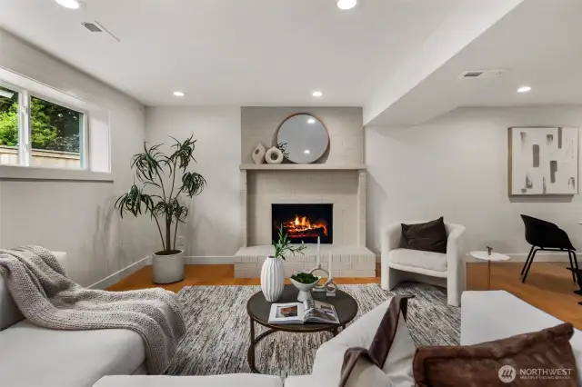 Open downstairs living space with fireplace