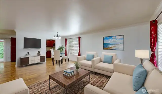 Bright and welcoming open-concept living and dining space offers a comfortable, modern feel with laminate flooring