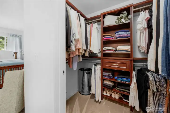 spacious walk-in closet with gorgeous custom shelves within the primary bedroom-