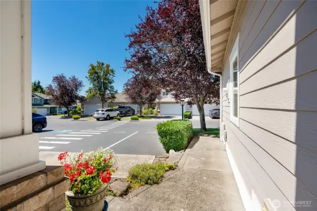 Serene community view with quiet neighborhood street and ample guest parking near 10700 SE 260th St Unit E-104, Kent.