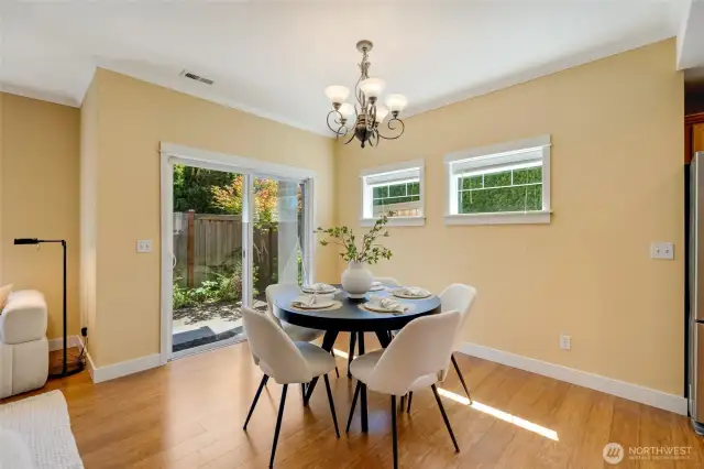 Bright dining area with modern lighting and views into the open kitchen—perfect layout for casual dining or hosting.