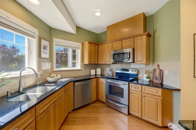 Functional kitchen with stainless steel appliances, electric stove, and ample cabinetry—perfect for the home chef.