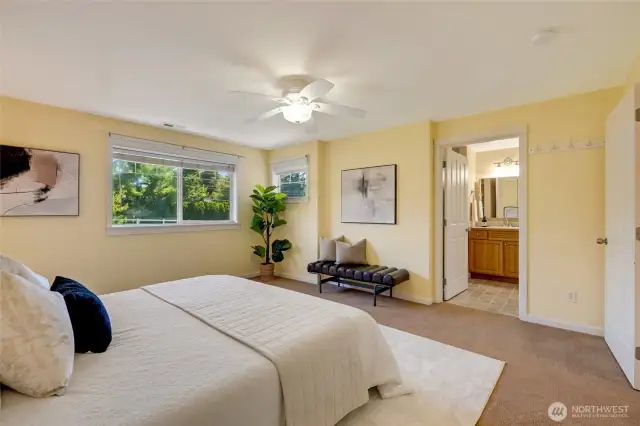Primary bedroom with ceiling fan and large windows—comfortable and relaxing retreat in Kent WA condo.
