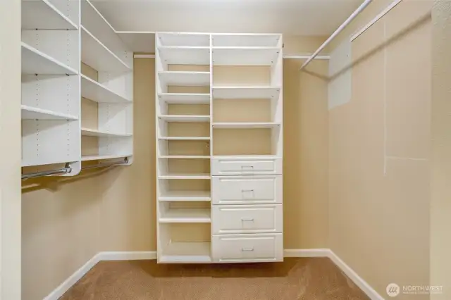 Primary walk-in closet with custom built-in shelving and ample storage—maximize organization in your Kent condo bedroom.