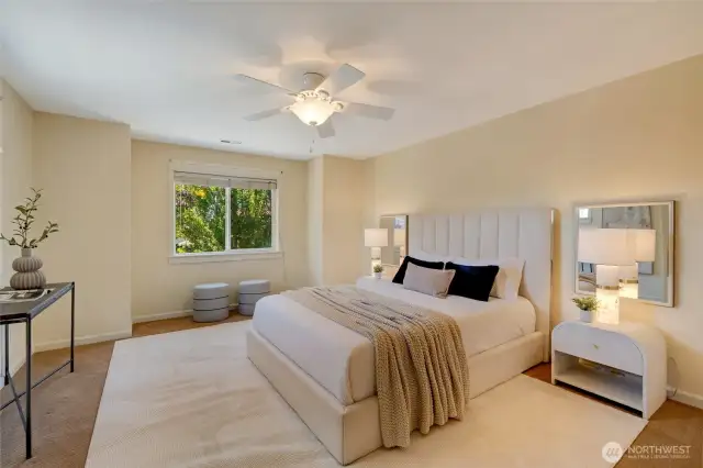 Spacious upstairs bedroom 3 with plush carpet, ceiling fan, and natural light—ideal retreat in this Kent townhome-style condo.