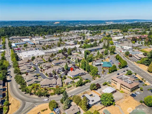 Wide-angle drone shot showing proximity to major roads, local schools, and Kent’s thriving residential area.