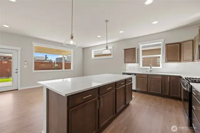 The kitchen is spacious & has an island with pullout drawers in the lower cabinets.