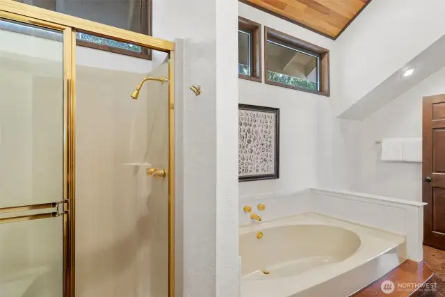 A view of the shower and soaking tub in the primary en-suite bath