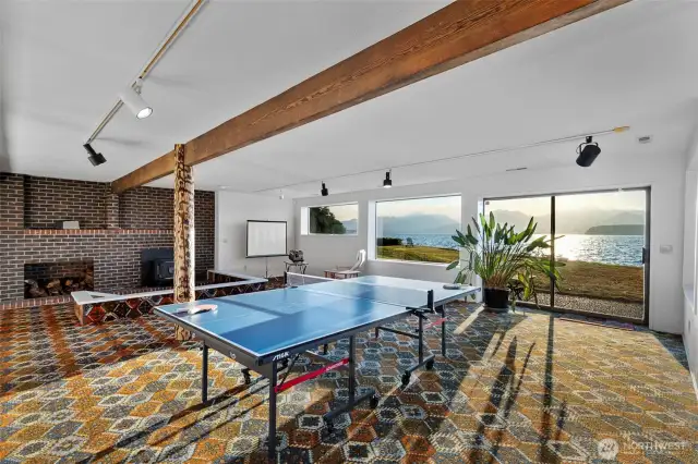 There is a large fireplace with a conversation pit area.  Just think of the wonderful things you could do with this space.  Thh large sliding glass doors open to a patio area and then to the bulkheaded beach