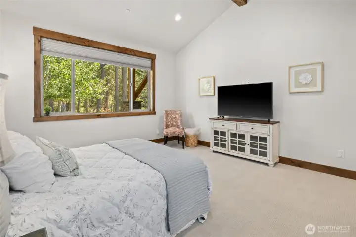 Oversized primary bedroom with vaulted ceilings