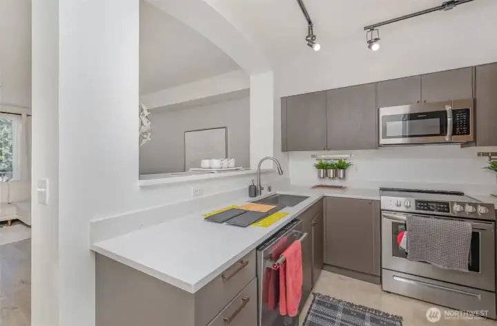 Kitchen features neutral-toned cabinetry, premium stainless steel appliances, and plenty of storage.