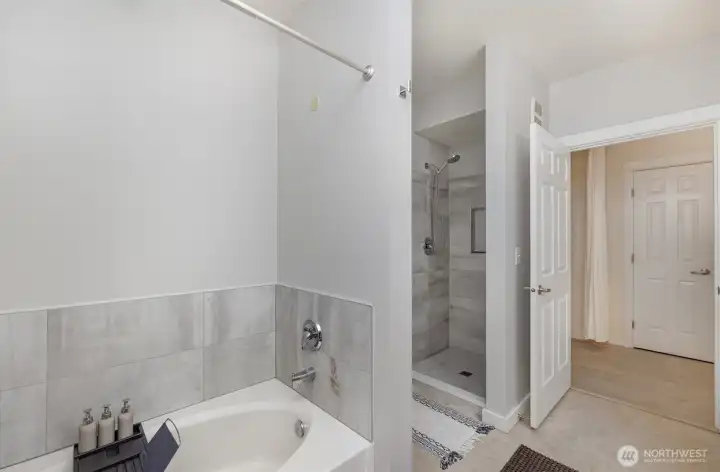 Bathroom features the luxury of both a separate shower and soaking tub.