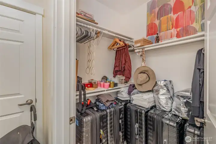 Second primary walk-in closet with functional shelving.