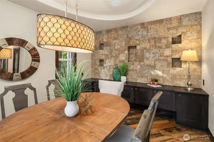 Formal dining room off of kitchen is perfect for all your holiday events.  It features a cultured stone wall with spa like feel and cantilevered ceiling.