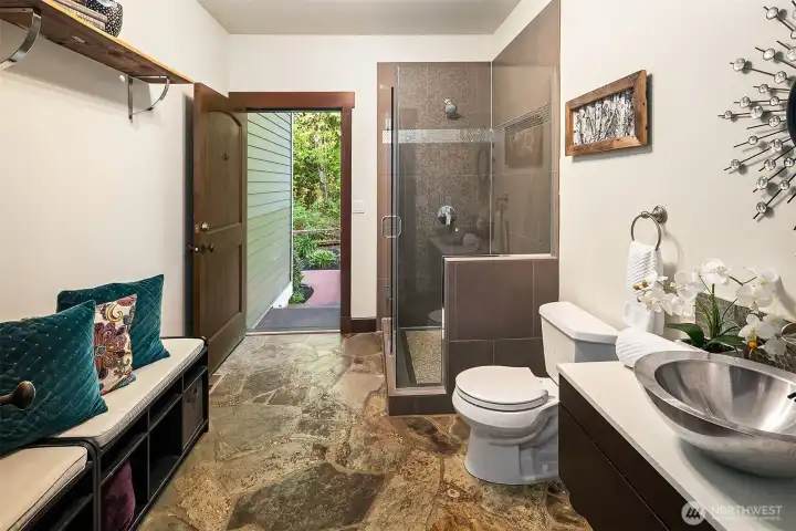 3/4 bath on main floor has indoor-outdoor access for showering off after a swim, but can be closed off from the house if desired.