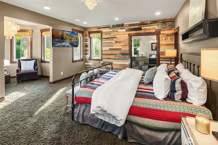 Primary bedroom offers 2 walk in closets, and stunning reclaimed barnwood accent wall.