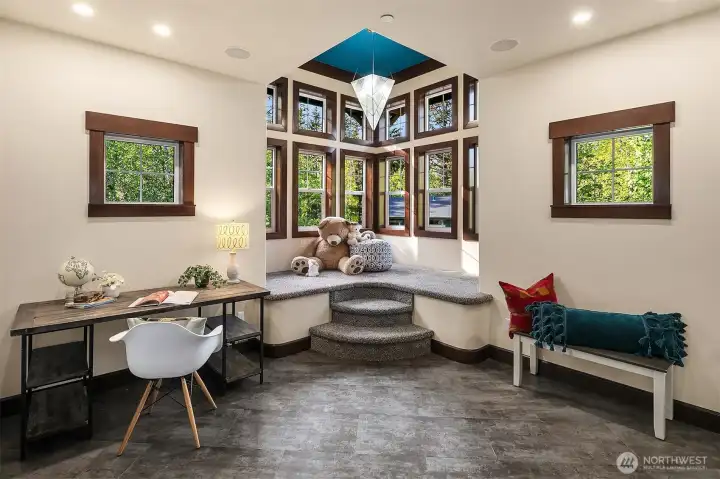 Carpeted bench in turret is the perfect place to read, work puzzles or play games