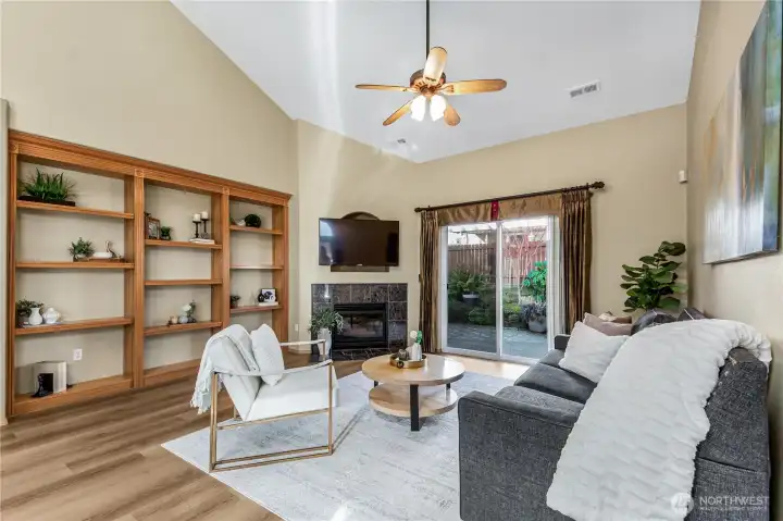 The living area has built in shelves and high ceilings.