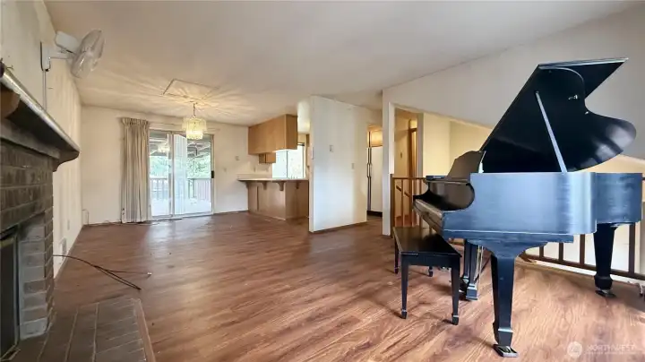 Nice and bright spacious living room with brick fireplace opens to dining